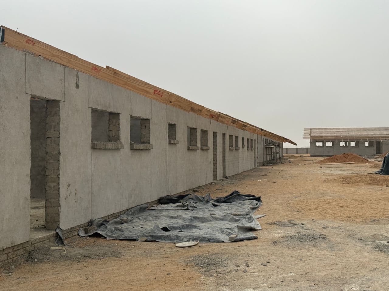A building under construction on an open site