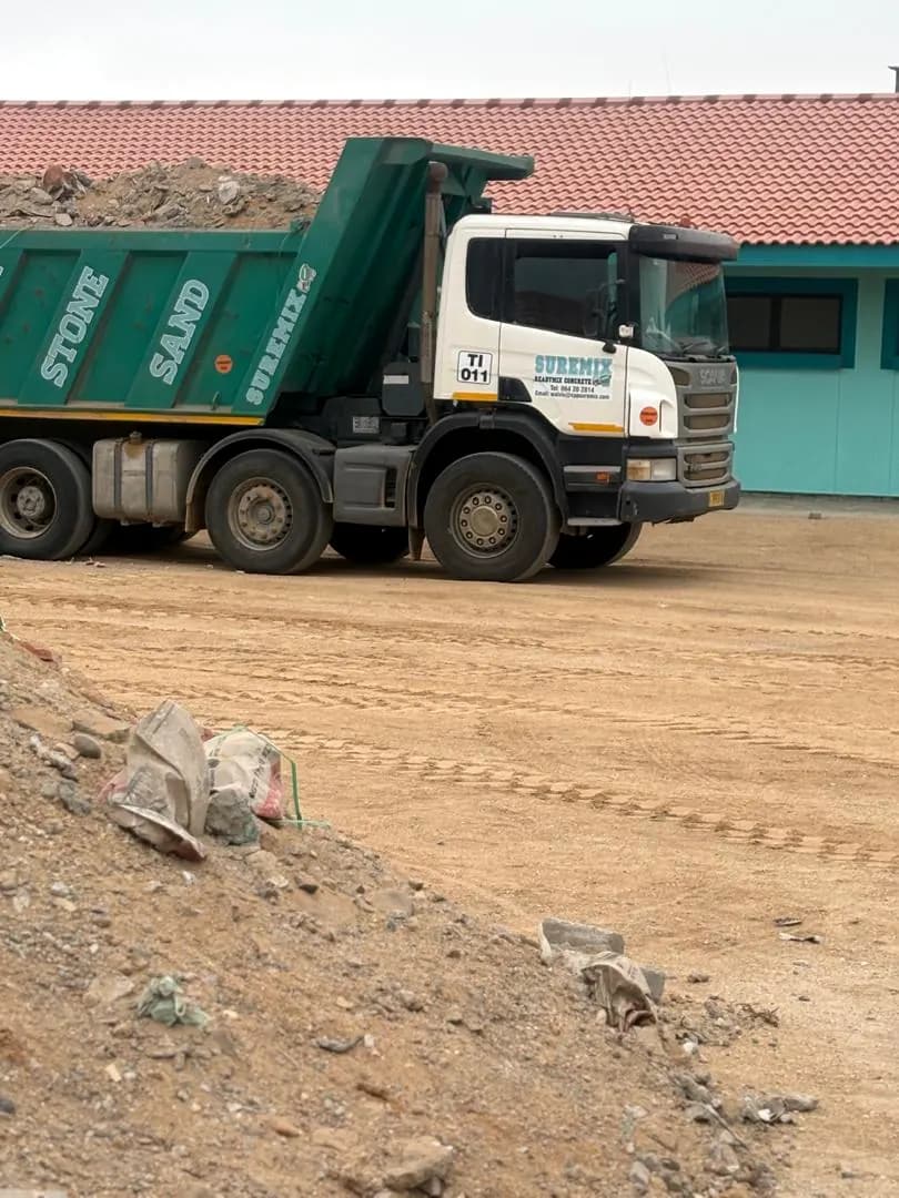 Tipper truck delivering fill material on a construction site