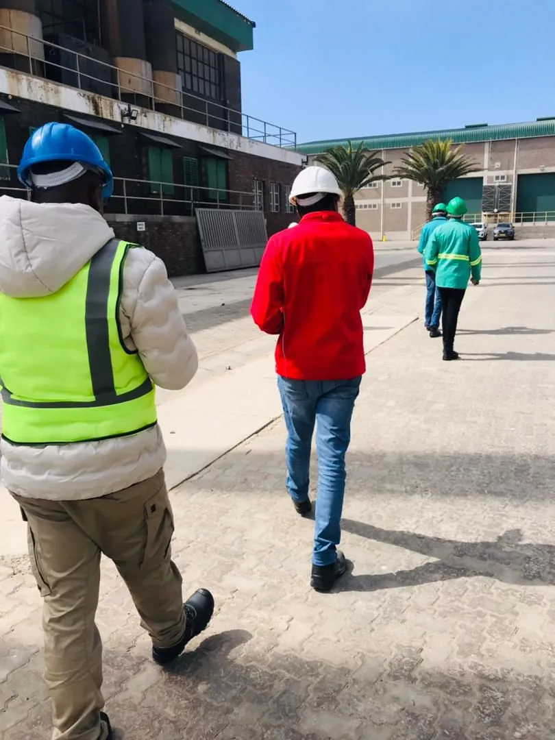 A team walking through an operational facility area