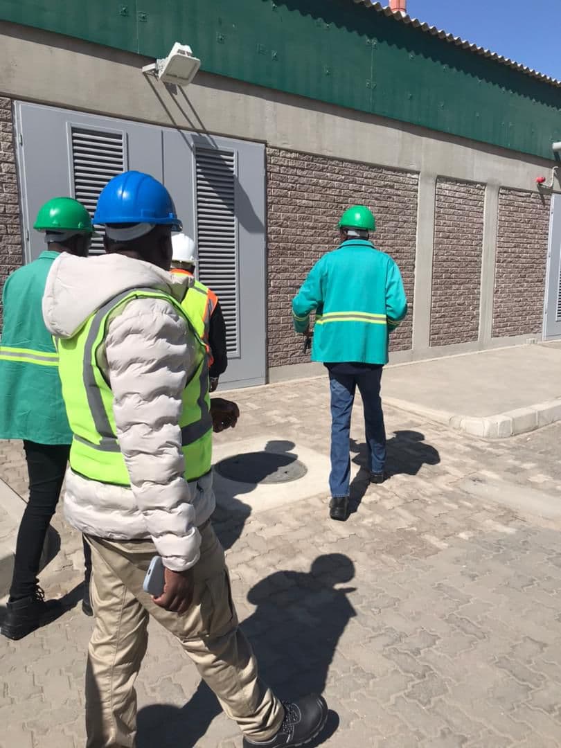 A team walking beside industrial service equipment