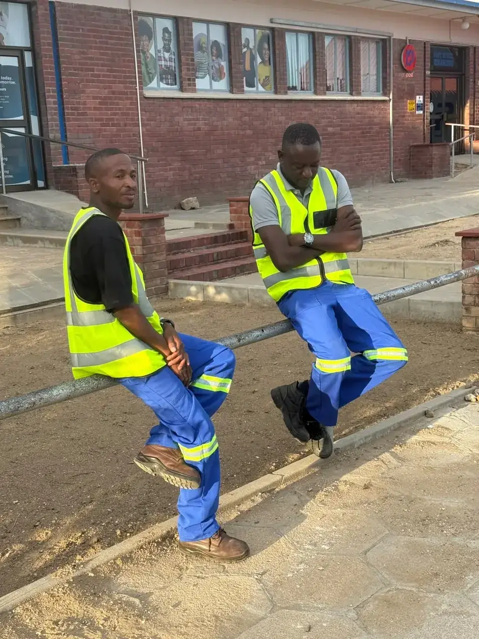 Mendozer crew members in branded high-visibility site wear, second view