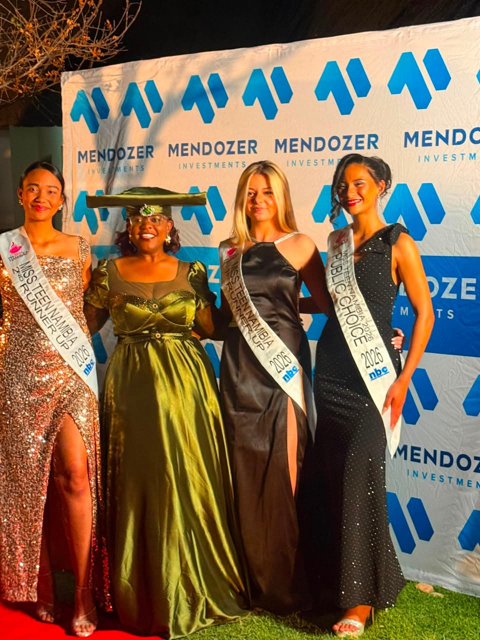 Guests at a Mendozer-branded event backdrop