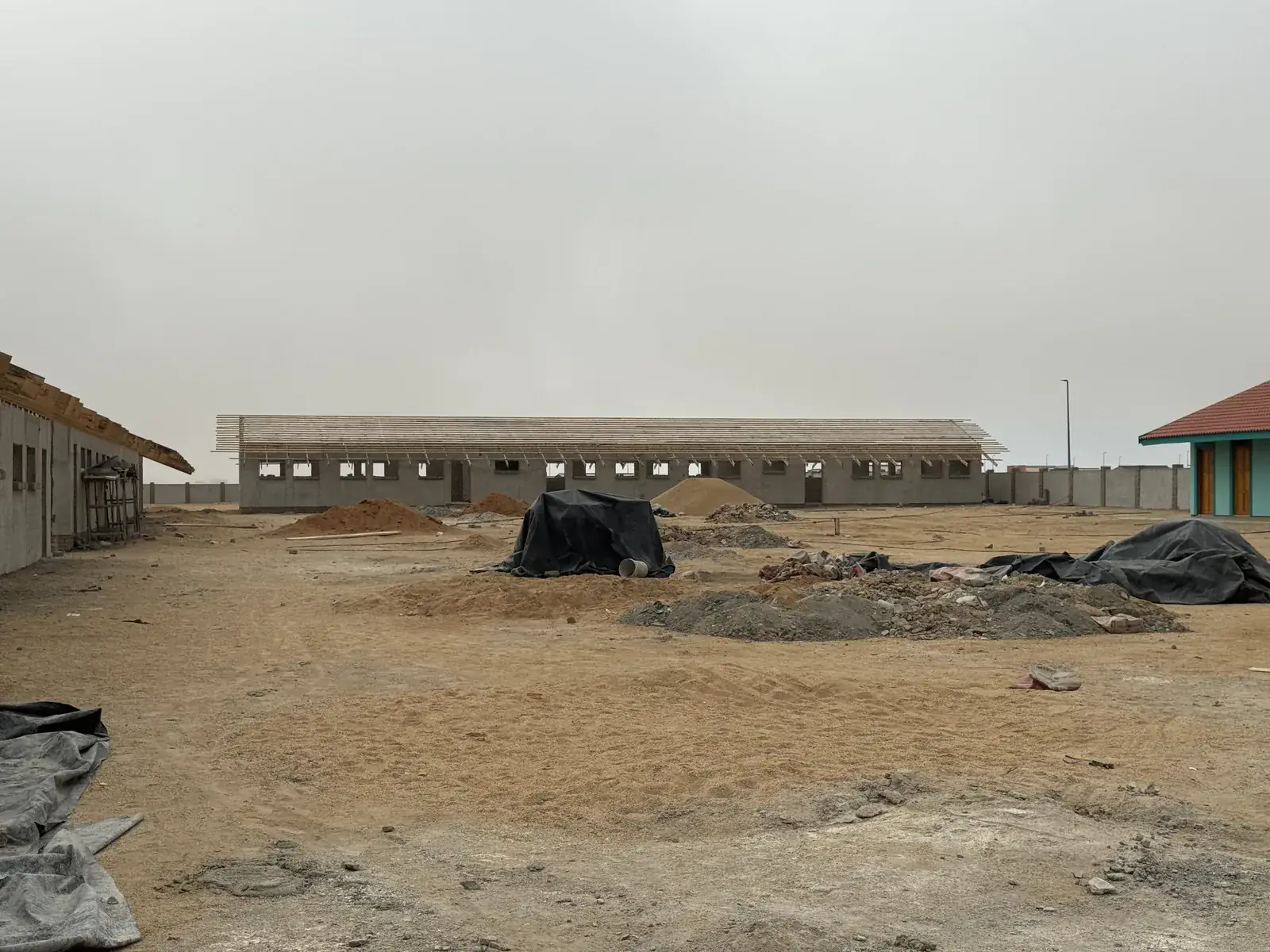 Broad view across a building work site with structures under construction