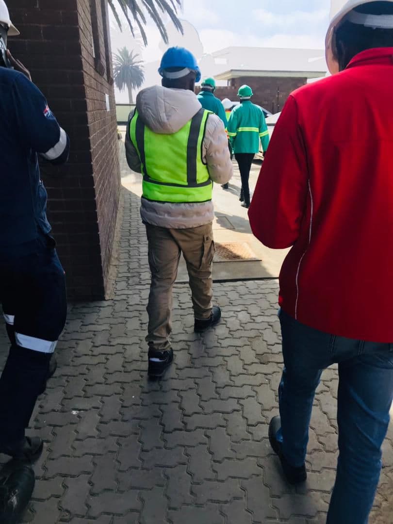 A group walking through a work environment