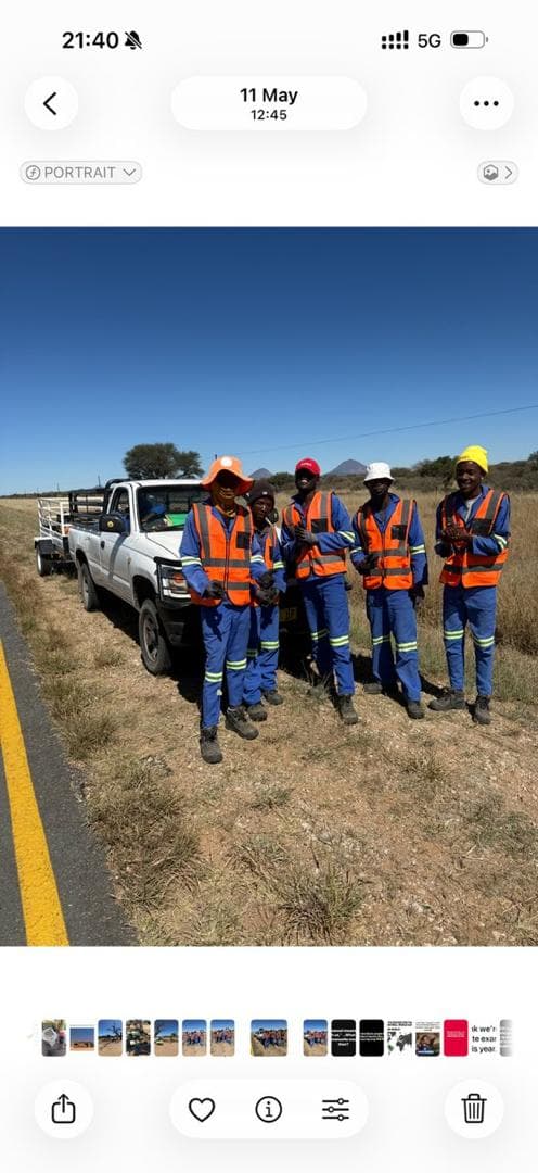 A work crew gathered beside a road